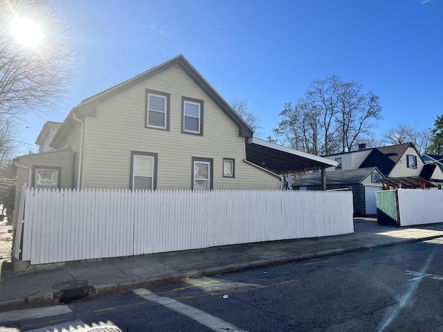 view of side of property featuring fence