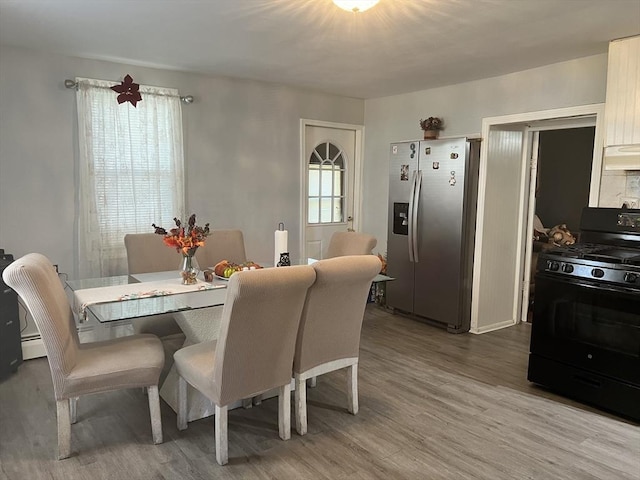 dining area with wood finished floors