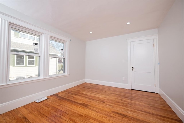 empty room with light hardwood / wood-style floors