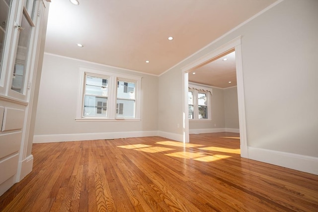 unfurnished room featuring crown molding and light wood-type flooring