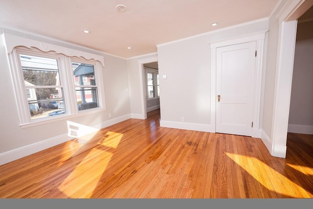 empty room featuring ornamental molding and light hardwood / wood-style floors