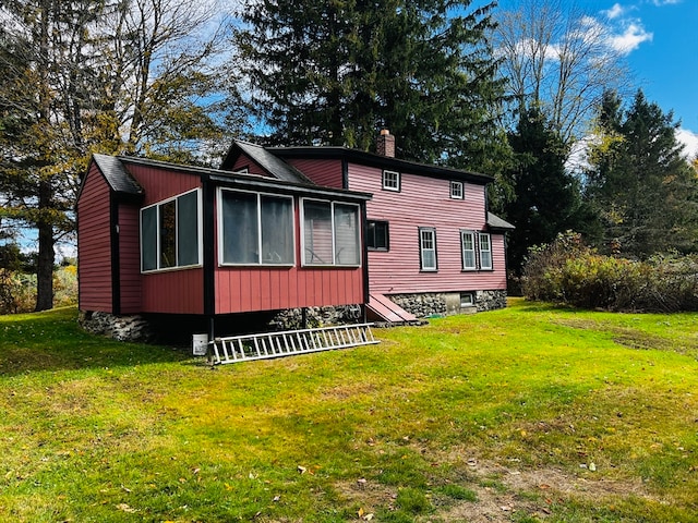 back of property featuring a yard