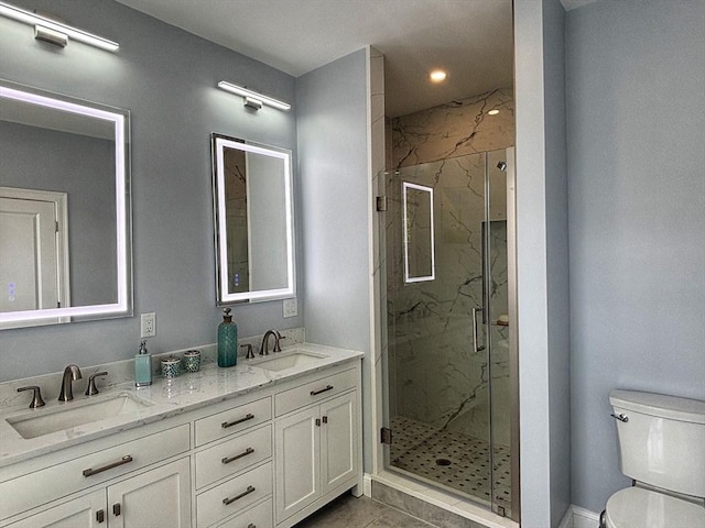 bathroom featuring toilet, a marble finish shower, double vanity, and recessed lighting