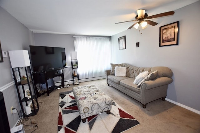 carpeted living room with ceiling fan