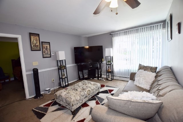 living room featuring ceiling fan, light colored carpet, and baseboard heating