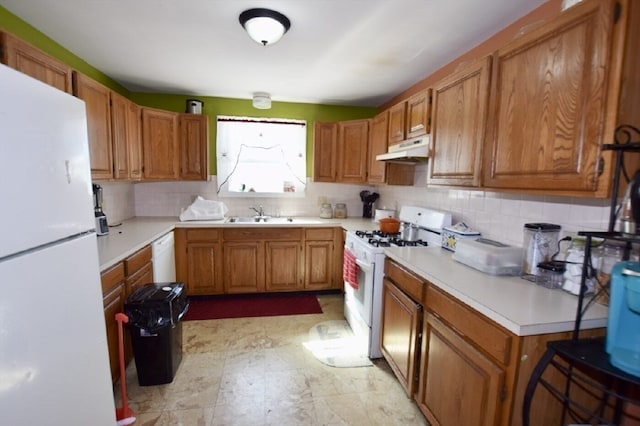 kitchen featuring decorative backsplash, white appliances, and sink