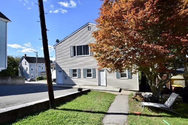 rear view of house featuring a yard