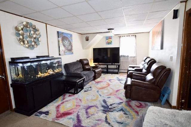 living room featuring light colored carpet and a paneled ceiling