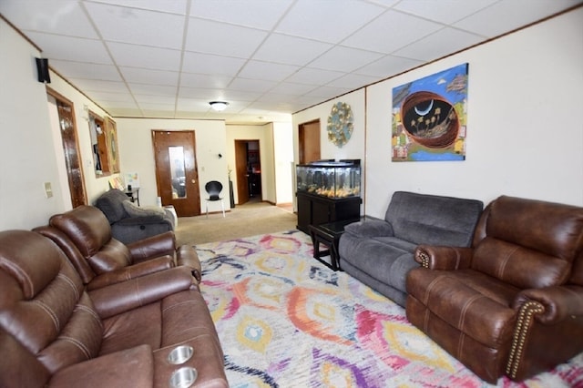 carpeted living room with a drop ceiling