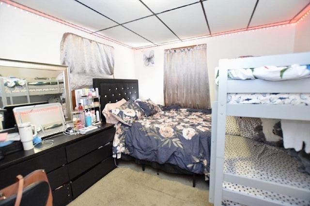 carpeted bedroom featuring a paneled ceiling