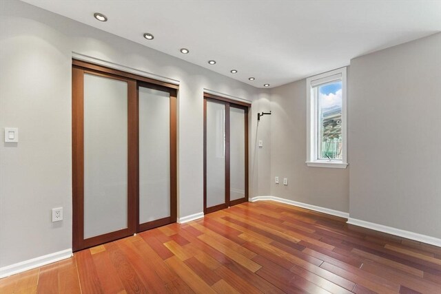 10 Rogers St Unit Ph19, Cambridge, MA 02142 - unfurnished bedroom featuring baseboards, light wood-style flooring, and recessed lighting