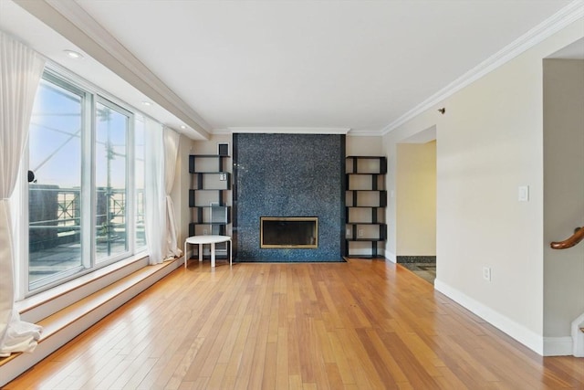 10 Rogers St Unit Ph19, Cambridge, MA 02142 - unfurnished living room with a fireplace, crown molding, hardwood / wood-style flooring, and plenty of natural light