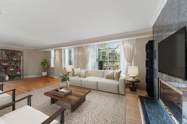 10 Rogers St Unit Ph19, Cambridge, MA 02142 - living area featuring crown molding, a wealth of natural light, baseboards, and light wood-type flooring