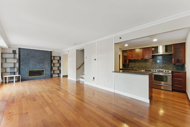 10 Rogers St Unit Ph19, Cambridge, MA 02142 - unfurnished living room with ornamental molding, stairs, a tiled fireplace, and light wood finished floors