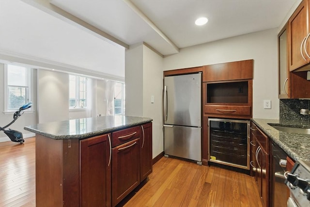 10 Rogers St Unit Ph19, Cambridge, MA 02142 - kitchen with beverage cooler, light wood-style flooring, a sink, freestanding refrigerator, and dark stone counters