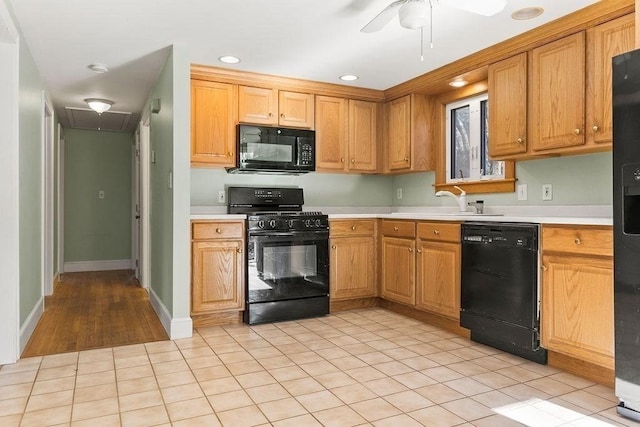 kitchen featuring black appliances, light countertops, a ceiling fan, and a sink