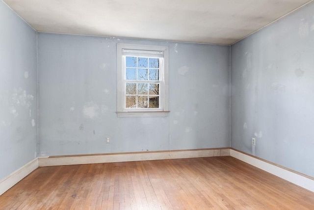 unfurnished room with hardwood / wood-style floors