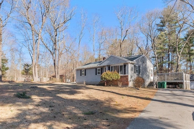 exterior space featuring a deck and driveway