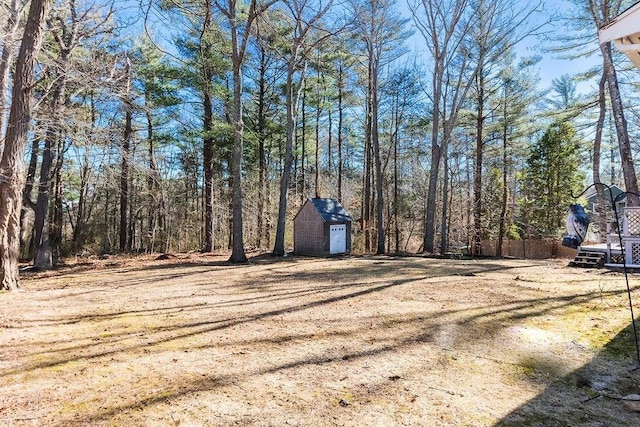 view of road with a wooded view and driveway