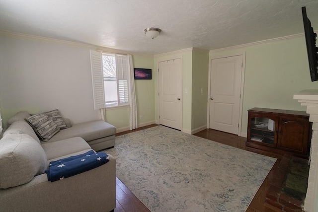 living room with crown molding, baseboards, and wood finished floors