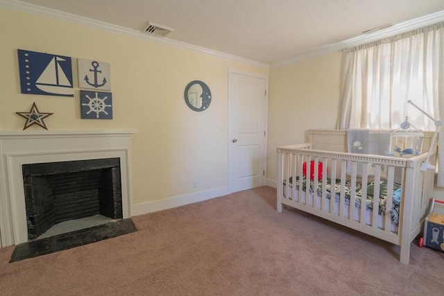 carpeted bedroom featuring visible vents, ornamental molding, baseboards, a crib, and a fireplace with flush hearth