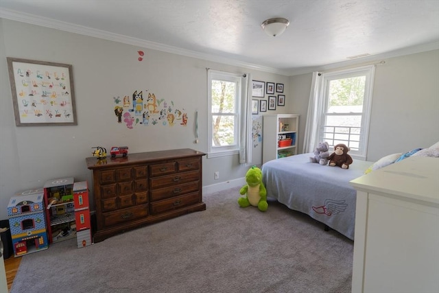 carpeted bedroom featuring crown molding and baseboards