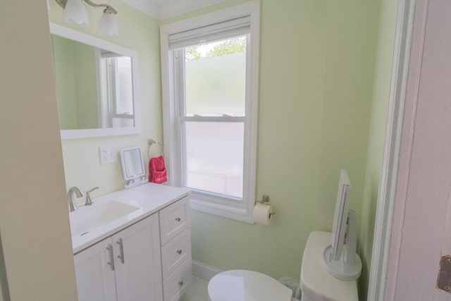 bathroom featuring crown molding, vanity, and toilet