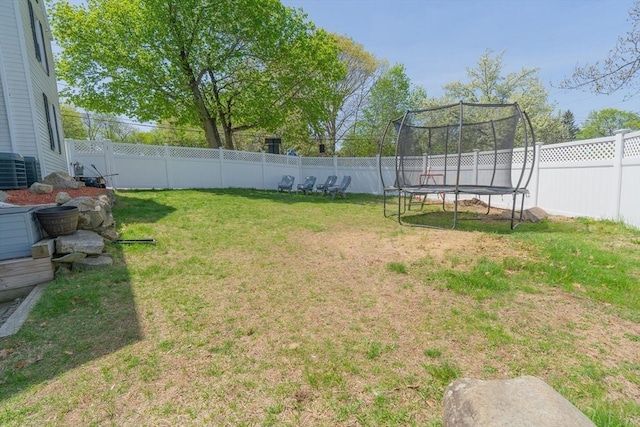 view of yard featuring a fenced backyard and a trampoline