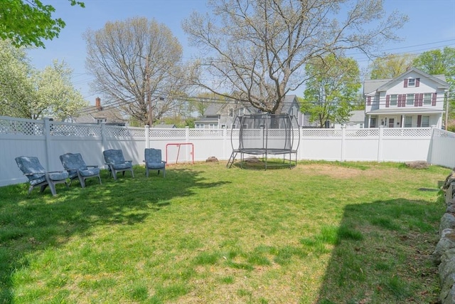 view of yard featuring a fenced backyard and a trampoline