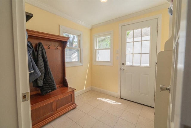 mudroom with crown molding, baseboards, and light tile patterned flooring