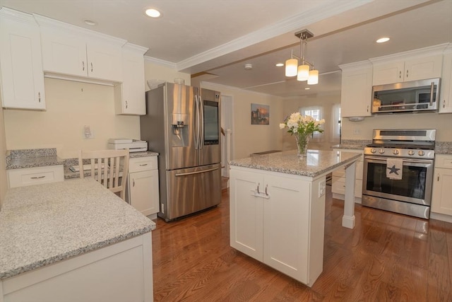 kitchen featuring ornamental molding, stainless steel appliances, dark wood finished floors, and white cabinetry