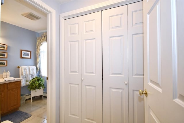bathroom featuring a closet, vanity, and tile patterned floors