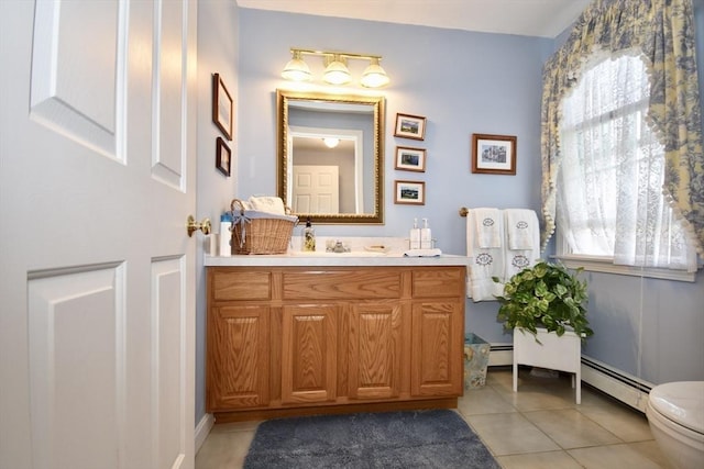 bathroom featuring a baseboard radiator, tile patterned floors, vanity, and toilet