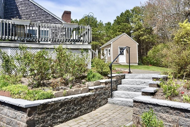 view of yard featuring an outdoor structure and a deck