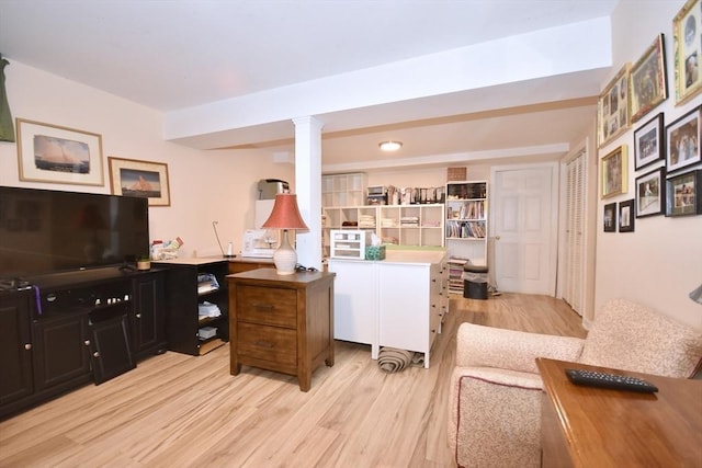 office featuring light wood finished floors and ornate columns
