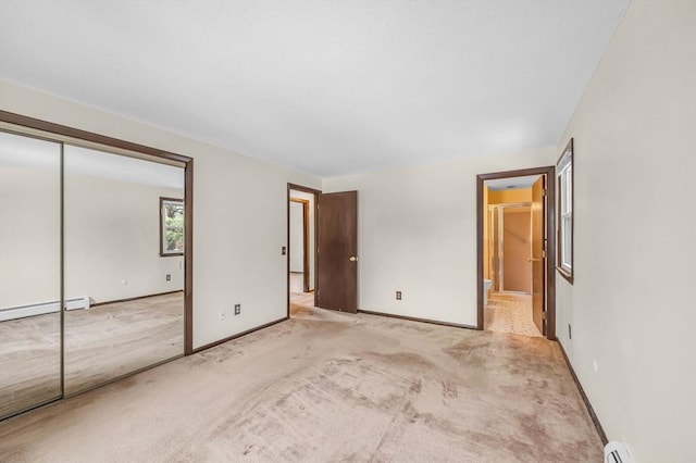 unfurnished bedroom featuring baseboards, a closet, and light carpet