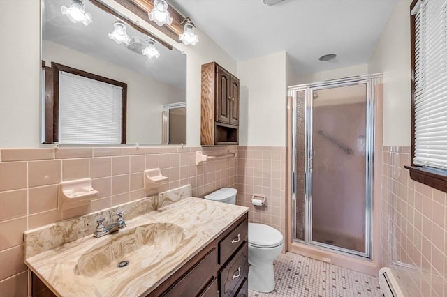 full bath featuring a shower stall, toilet, tile patterned floors, tile walls, and a baseboard radiator