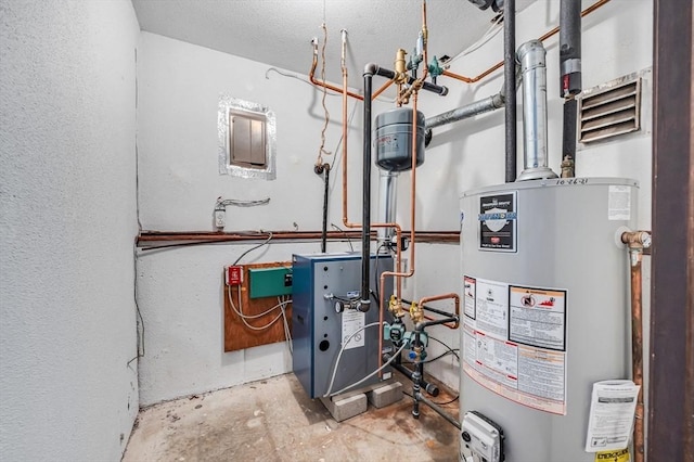 utility room featuring water heater and a heating unit