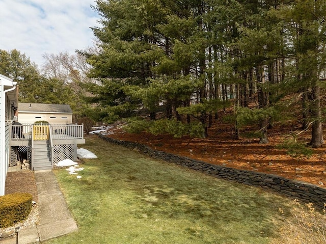 view of yard featuring a wooden deck and stairway