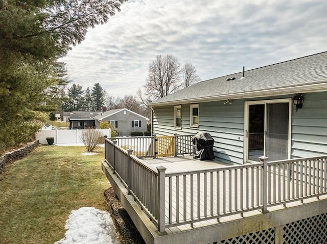 wooden deck with a lawn and fence