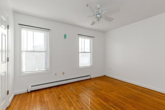 empty room featuring light wood finished floors, ceiling fan, baseboards, and a baseboard radiator