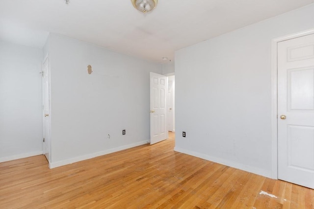 empty room with light wood-style floors and baseboards