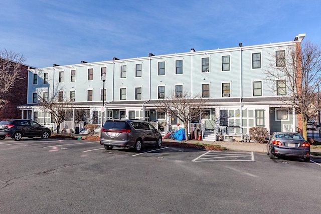 view of building exterior with uncovered parking