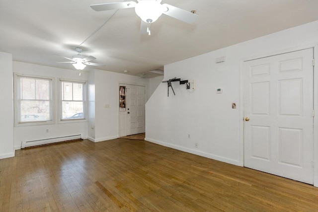 unfurnished living room with hardwood / wood-style floors, a ceiling fan, baseboards, and baseboard heating