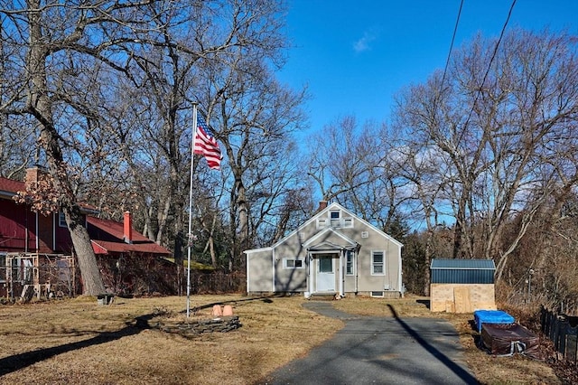 view of front of property featuring a shed