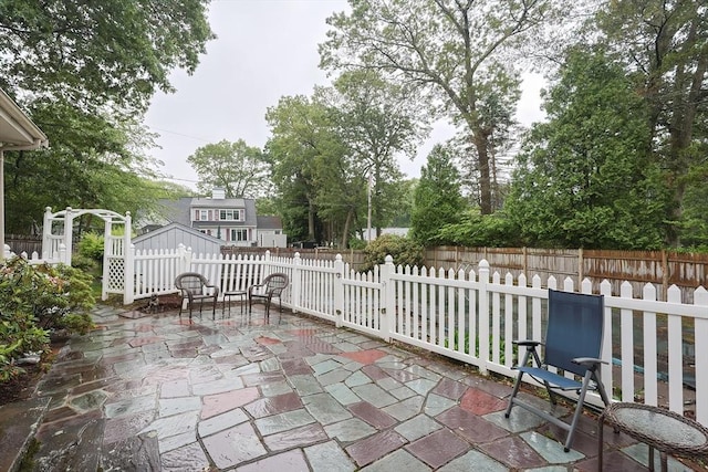 10 Victoria Cir, Norwood, MA 02062 - fenced backyard featuring a patio and a storage unit