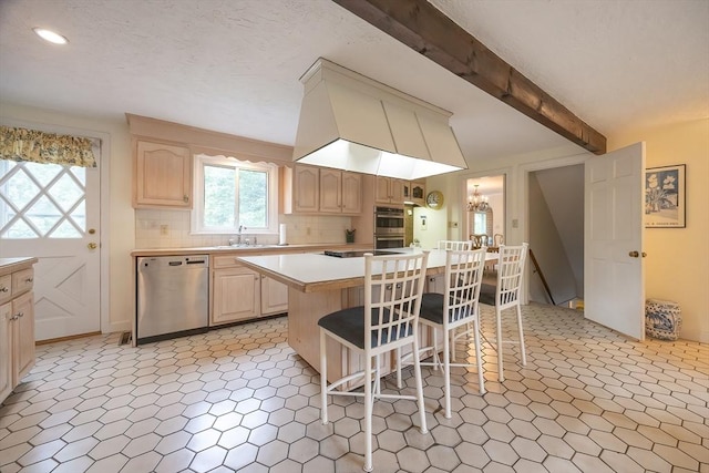 10 Victoria Cir, Norwood, MA 02062 - kitchen with stainless steel appliances, light countertops, a kitchen bar, light brown cabinetry, and decorative backsplash