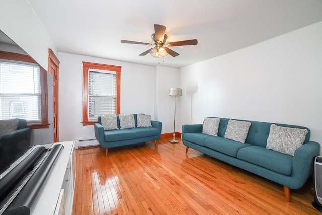 living room with ceiling fan, light hardwood / wood-style floors, and baseboard heating