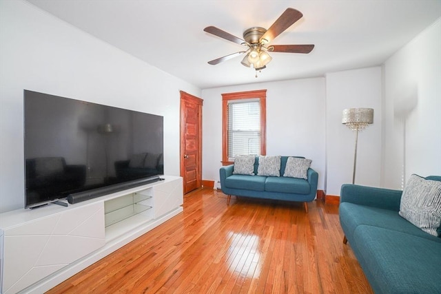 living room featuring ceiling fan and light wood-type flooring