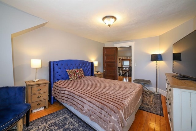 bedroom with hardwood / wood-style floors